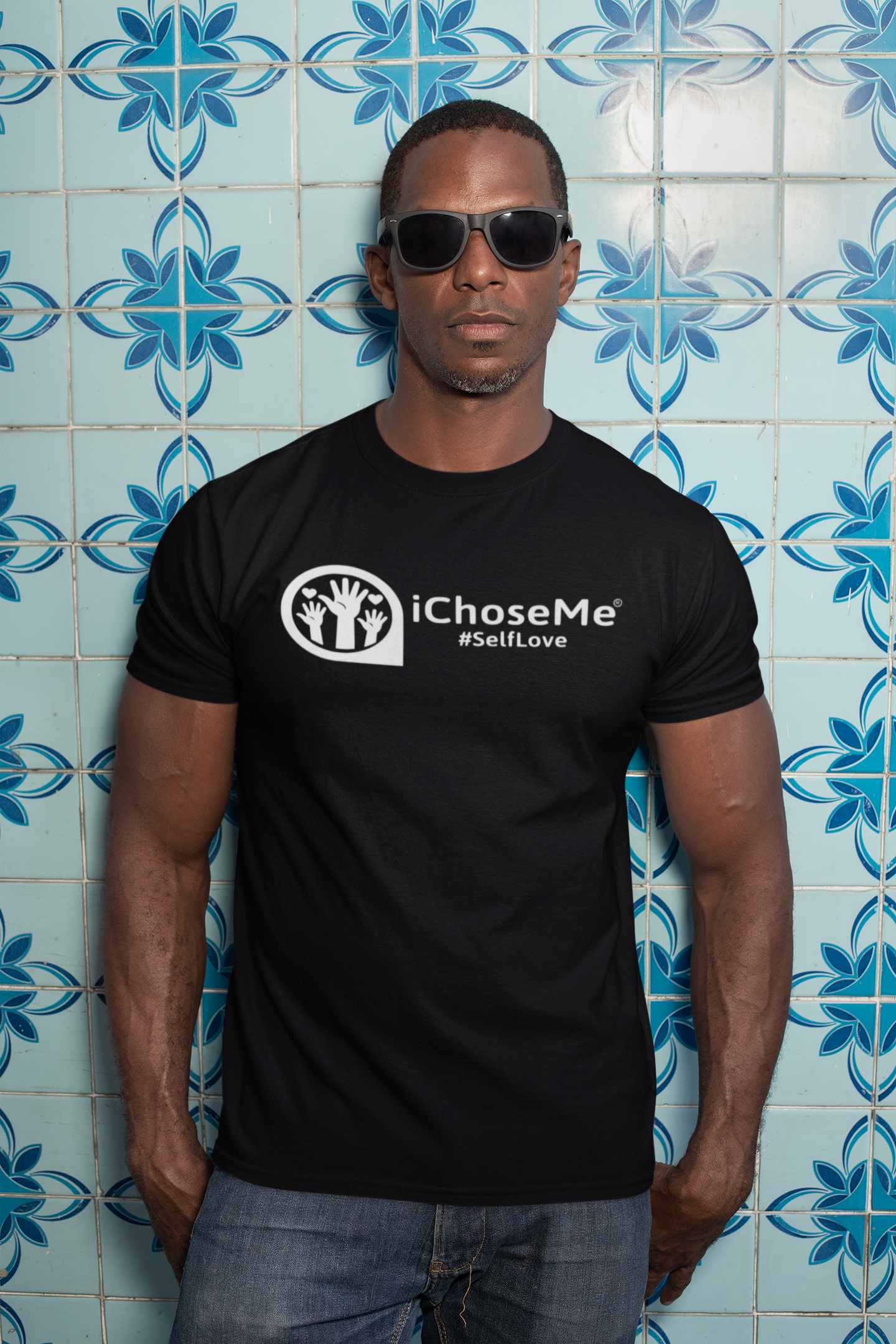 Black iChoseMe self love t-shirt worn by man with sunglasses against blue patterned tile wall