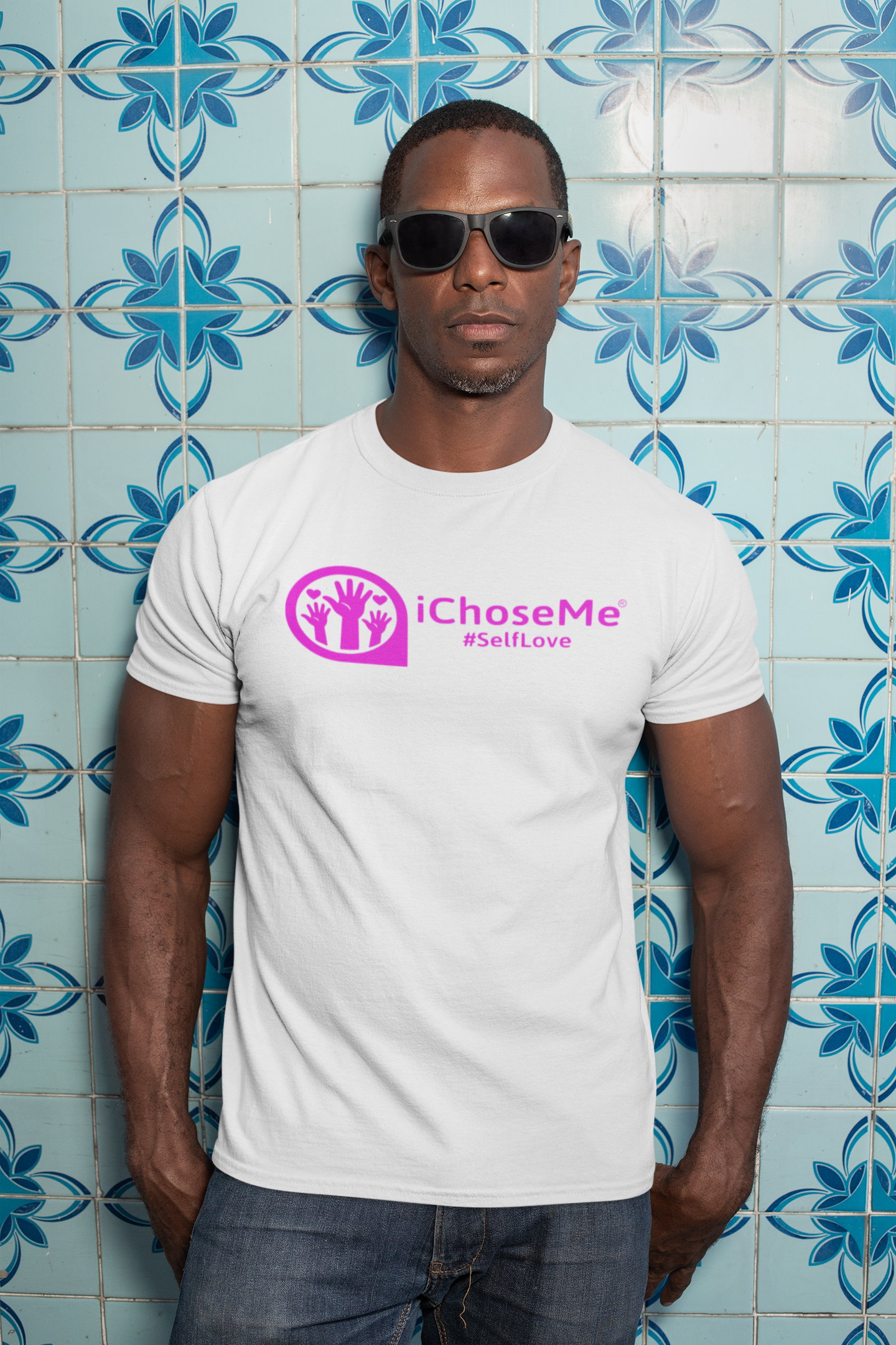 White iChoseMe self love graphic t-shirt worn by man with sunglasses standing against blue patterned tile wall