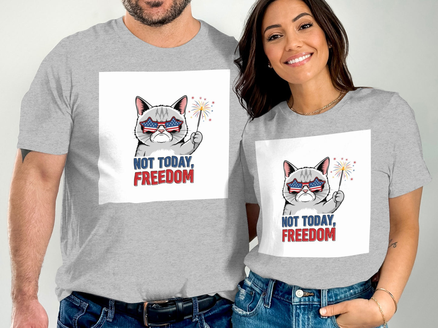 Two people wear grey t-shirts with a patriotic cat graphic and "Not Today, Freedom" text.