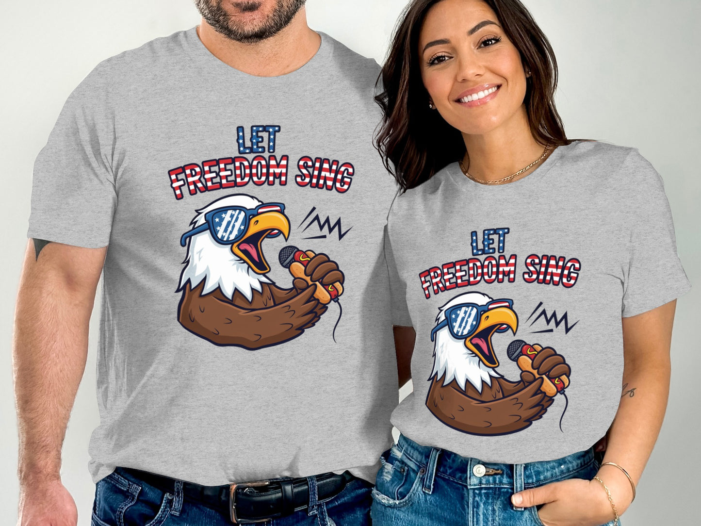 Couple wearing matching gray t-shirts with "Let Freedom Sing" and an eagle.