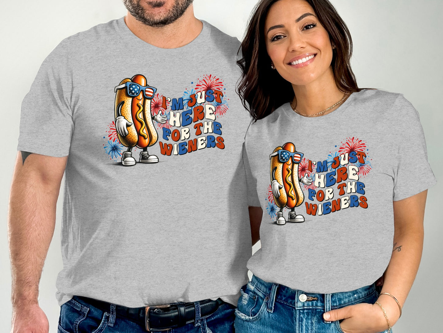 Couple wearing matching t-shirts with patriotic hot dog graphic.