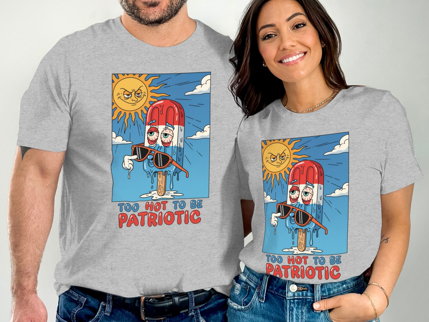 Two people wear gray t-shirts featuring a melting popsicle with sunglasses under a sun.