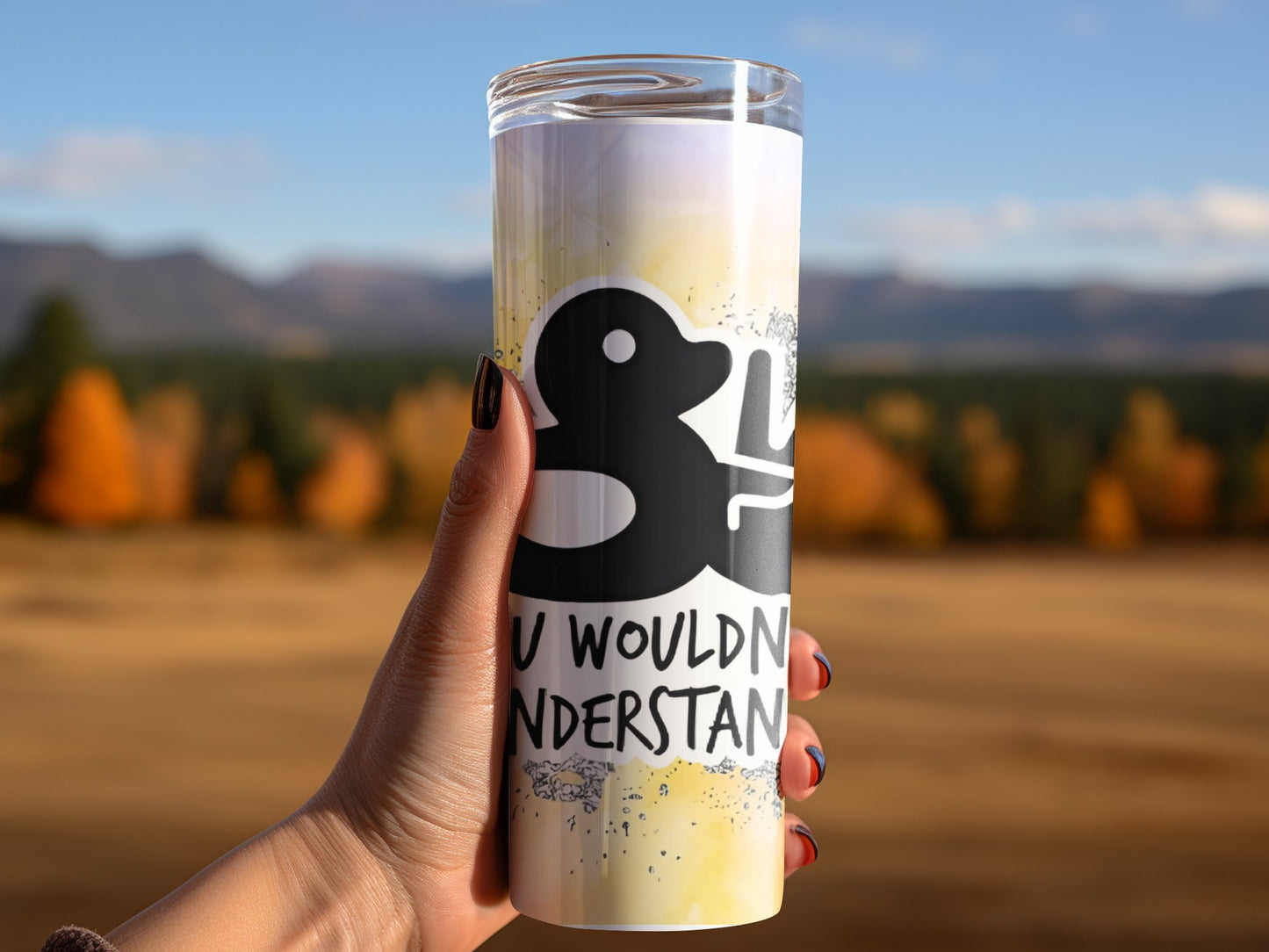 Funny duck tumbler gift held outdoors with humorous design and autumn background