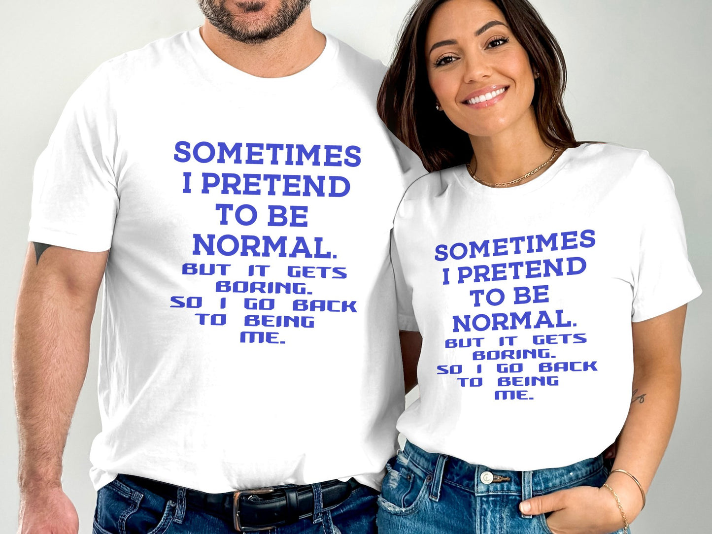 White T-Shirts with Sometimes I pretend to be Normal printed in blue text worn by smiling man and woman