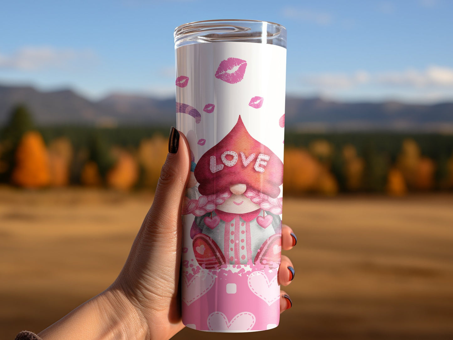Valentine's Day gnome tumbler with pink love heart design and lipstick kiss marks held outdoors