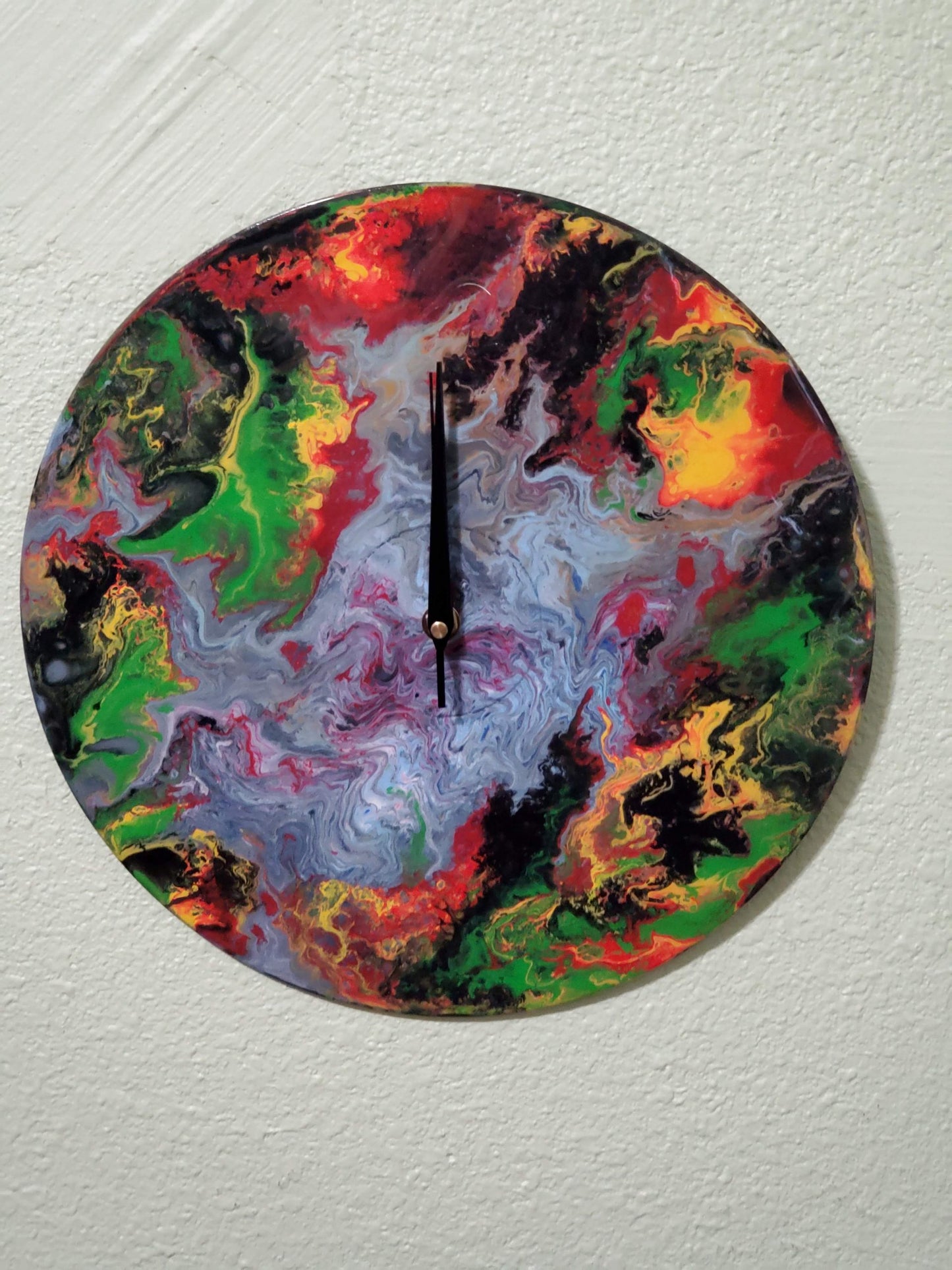 Colorful abstract wall clock decor with vibrant red, green, yellow, and purple swirls on round face