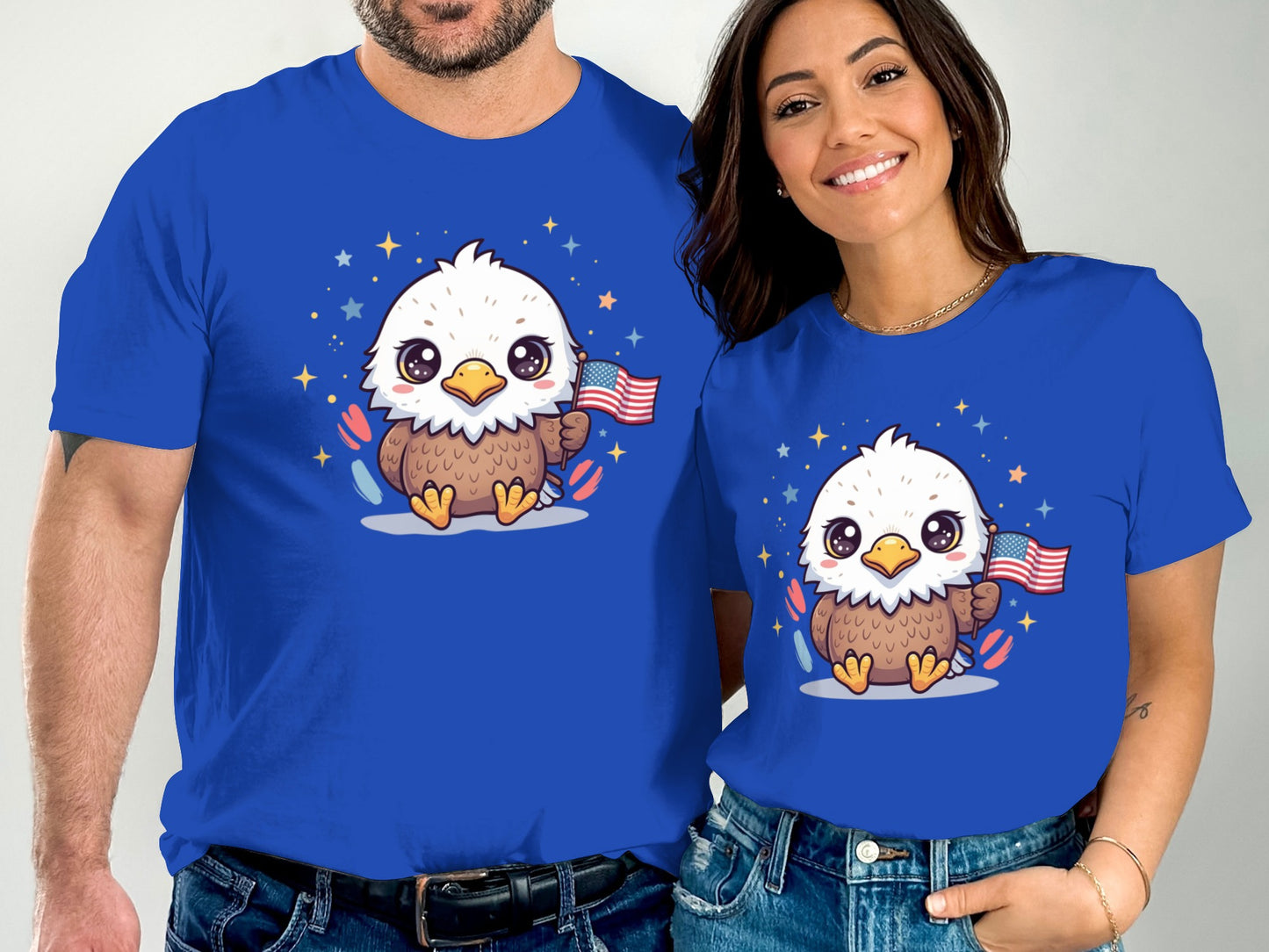 Couple wearing matching blue t-shirts with cartoon eagles holding American flags.