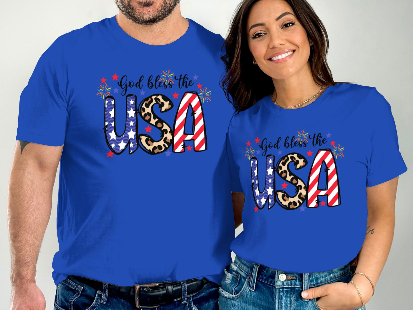 Couple wearing matching blue t-shirts with "God bless the USA" and patriotic designs.