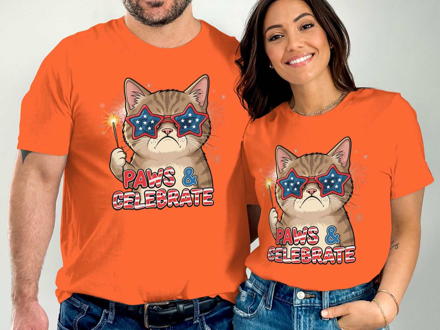 Couple wearing matching orange t-shirts with a patriotic cat graphic.