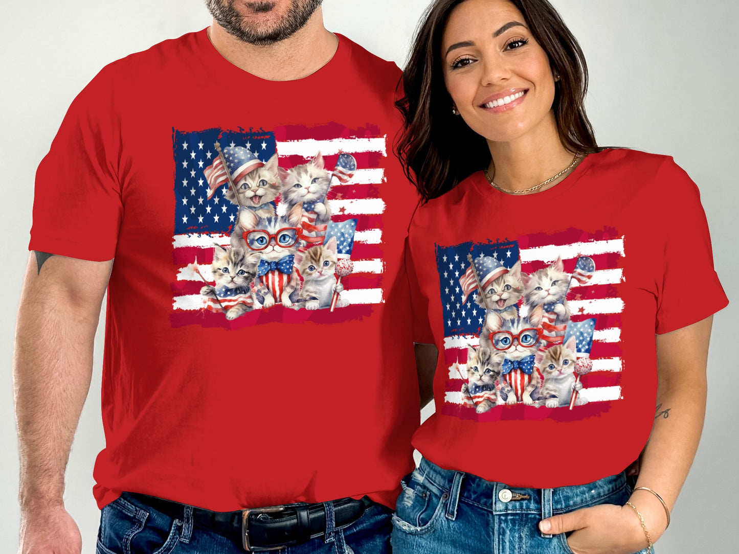 Two people in red t-shirts with American flag and kitten graphics.