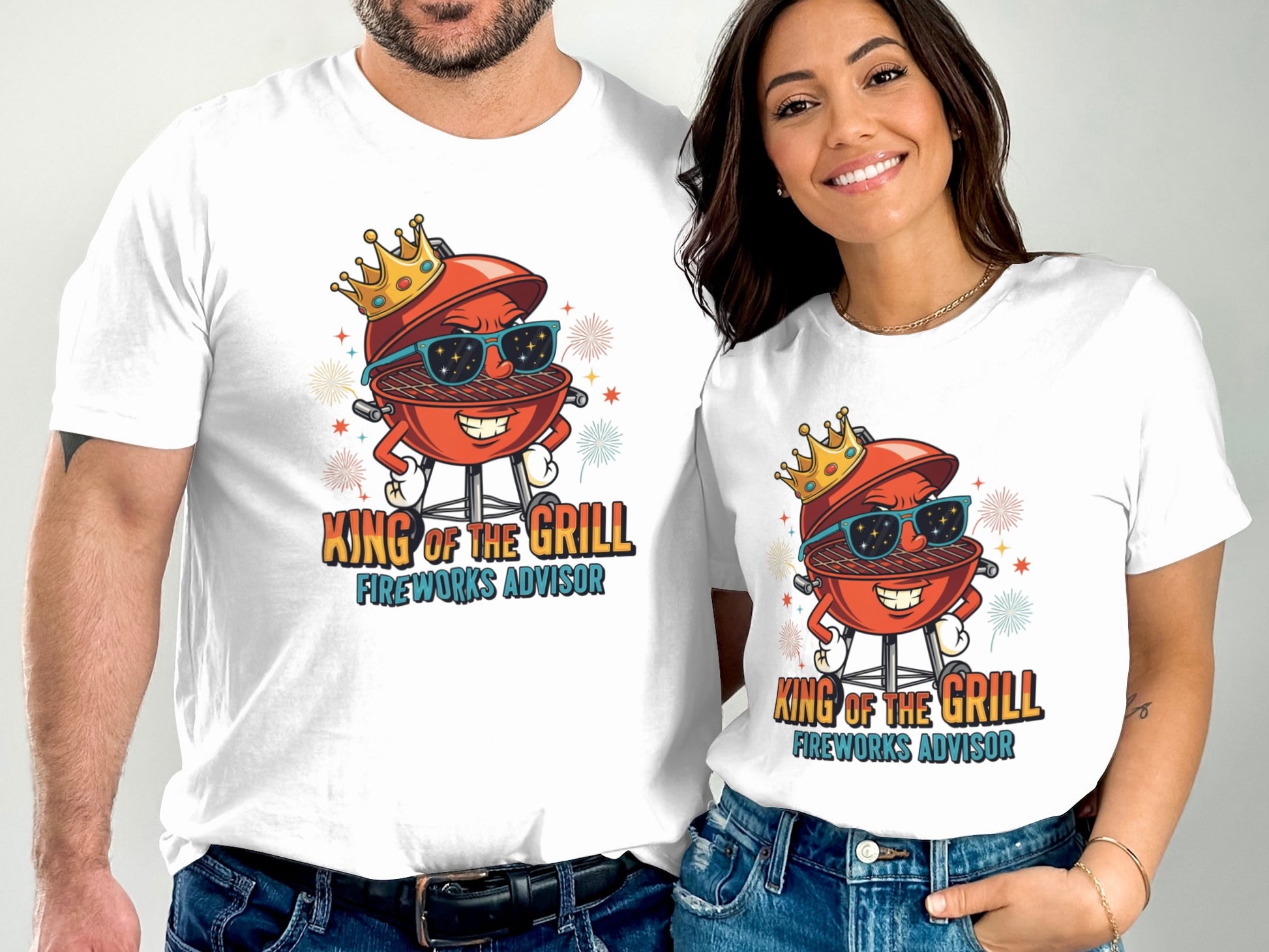 Couple wearing matching t-shirts with cartoon grill and "King of the Grill Fireworks Advisor" text.