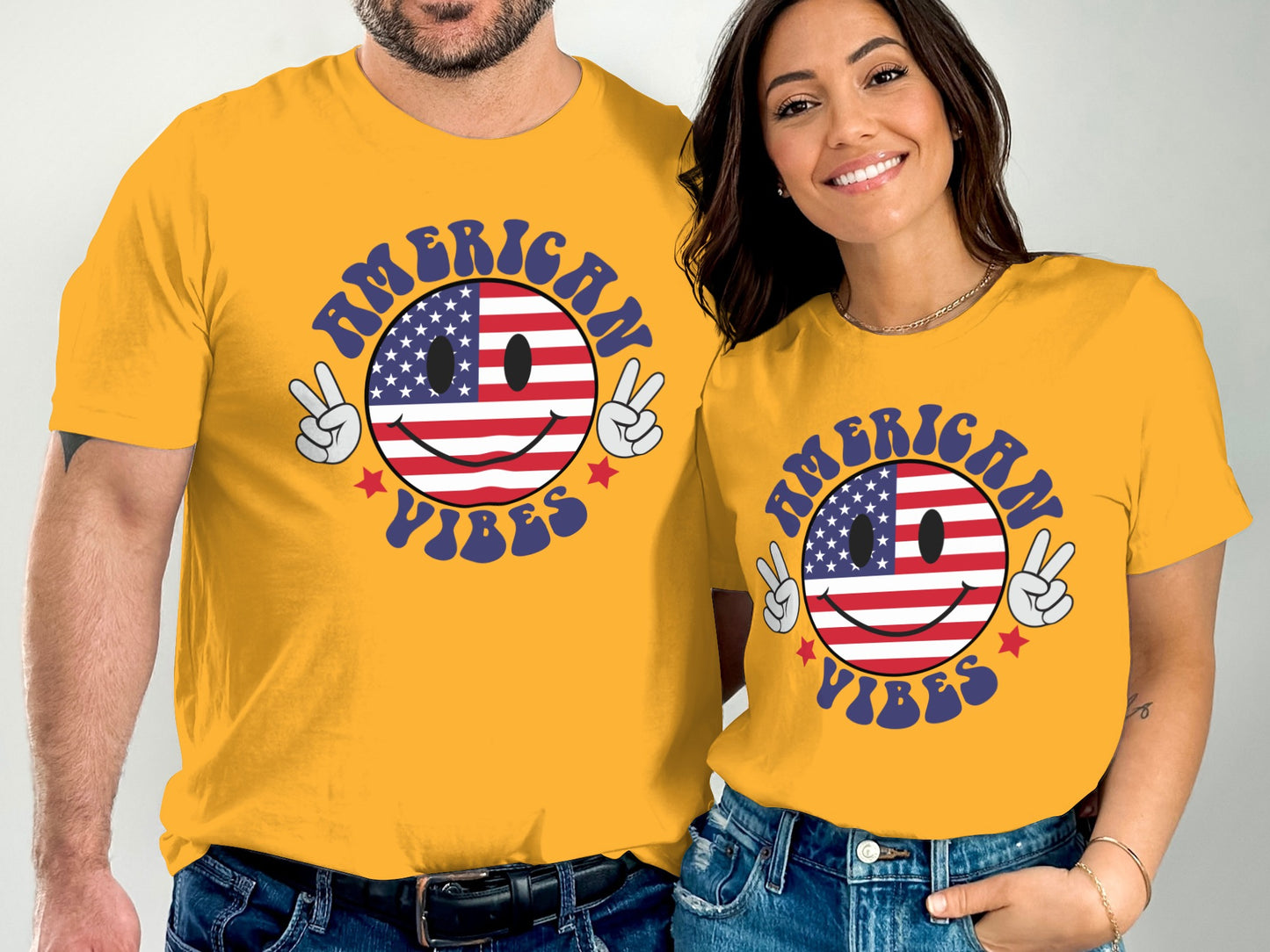 Couple in yellow t-shirts with American flag smiley face graphic.