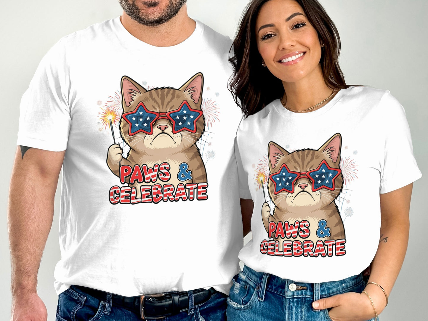Two people wear matching white t-shirts featuring a cat in star-spangled glasses.