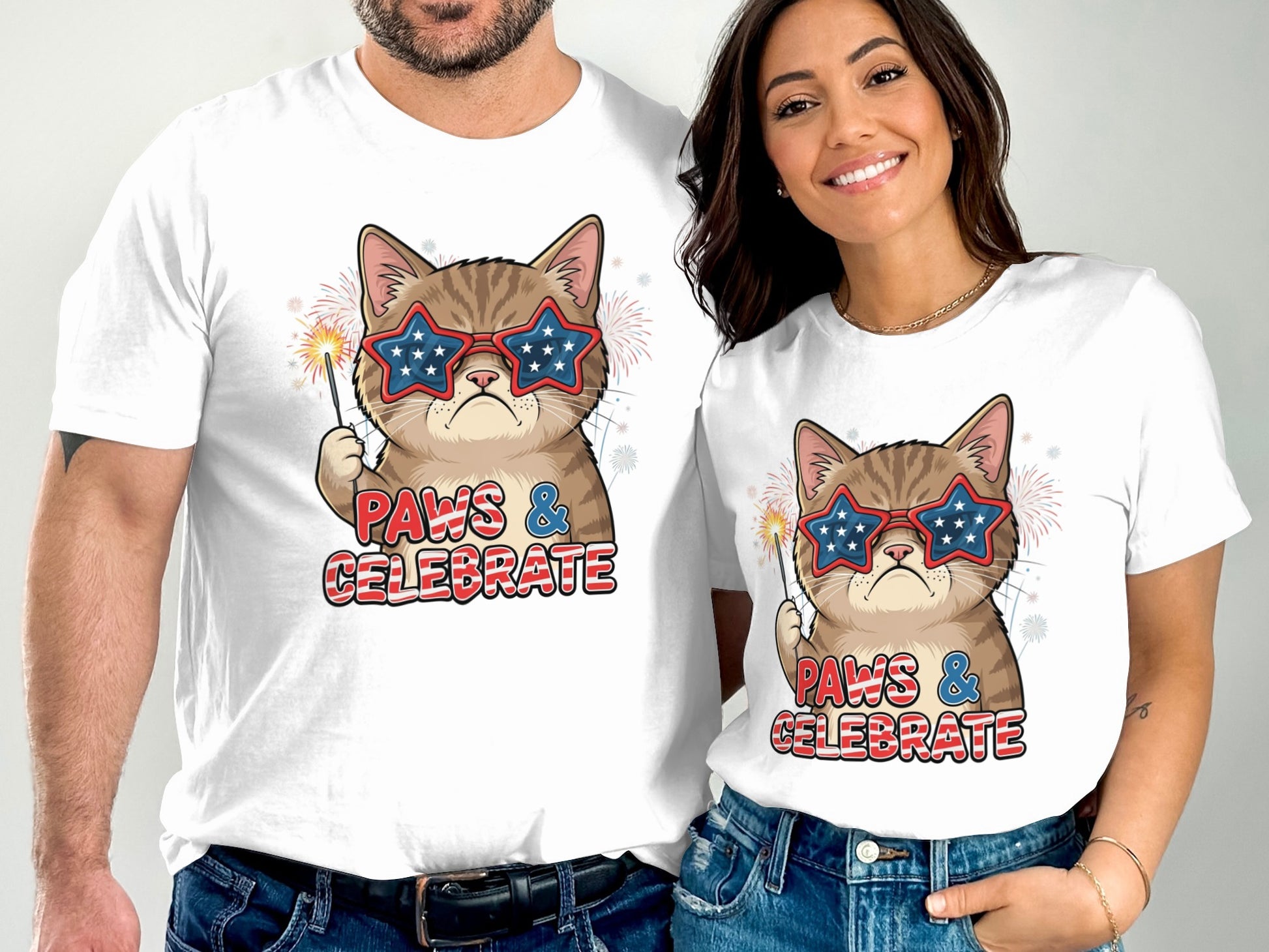 Two people wear matching white t-shirts featuring a cat in star-spangled glasses.
