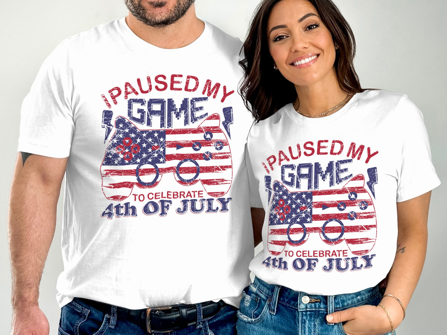 White t-shirts with "I Paused My Game to Celebrate 4th of July" text and US flag controller.