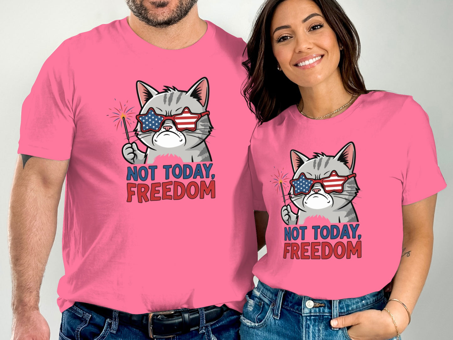 Couple wearing pink t-shirts with a cat graphic and text "NOT TODAY, FREEDOM".