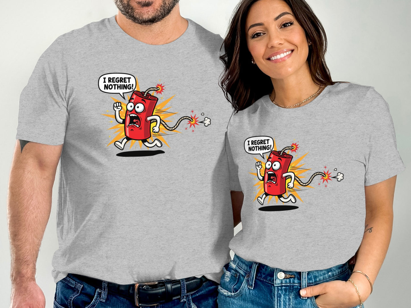 Two people wear matching gray t-shirts with a cartoon firecracker saying "I regret nothing!".
