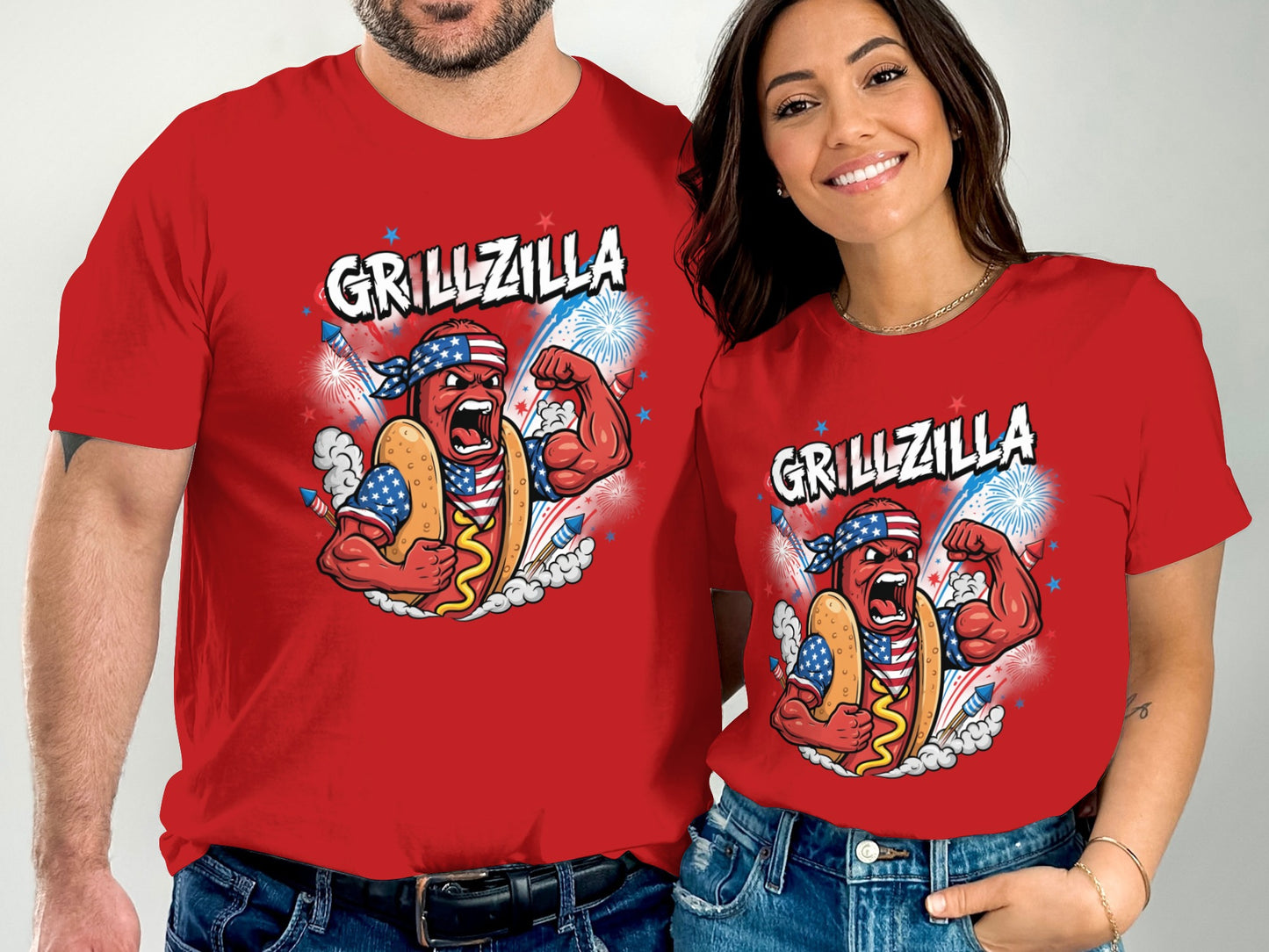 Couple wearing red t-shirts with "Grillzilla" and patriotic hot dog graphic.