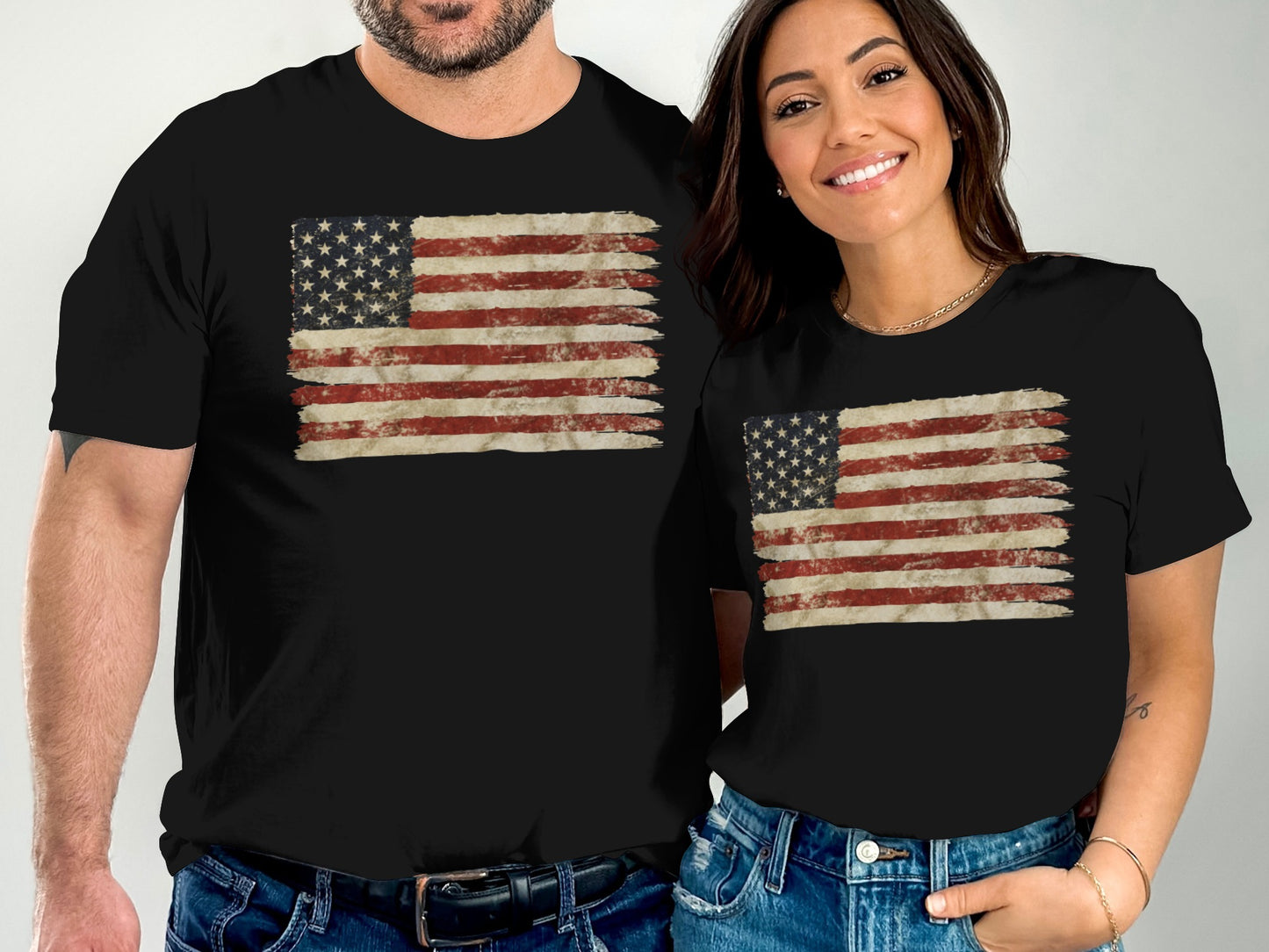Two people in black t-shirts with distressed American flag graphic print.