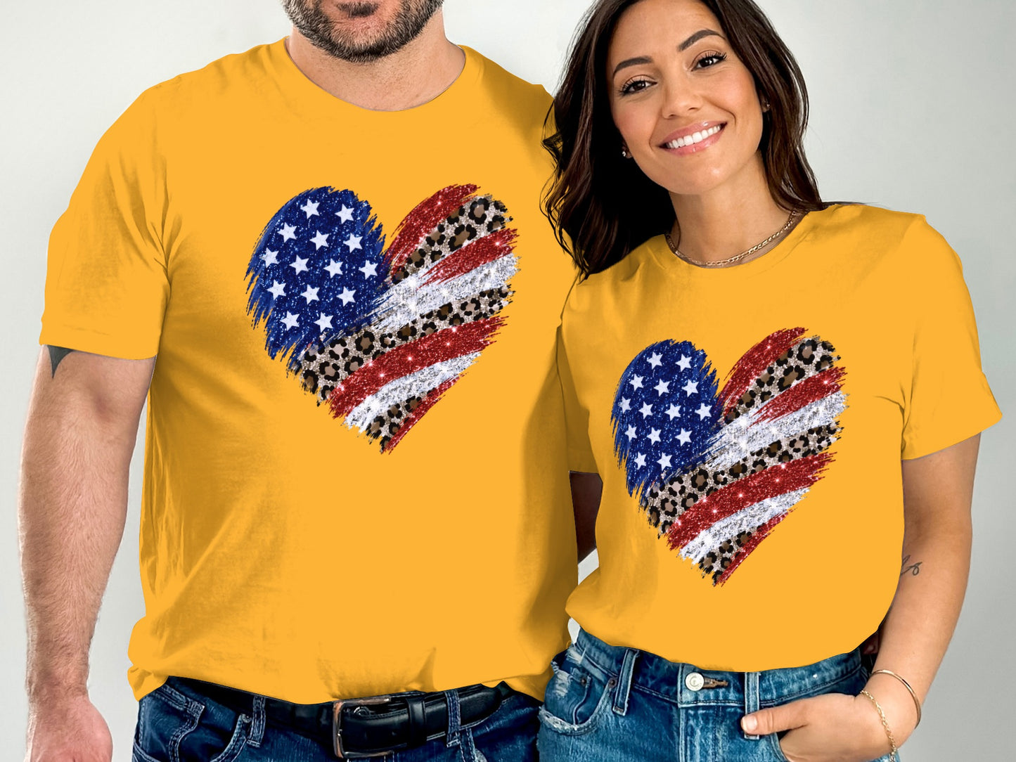 Couple in matching yellow t-shirts with American flag and leopard print heart graphics.