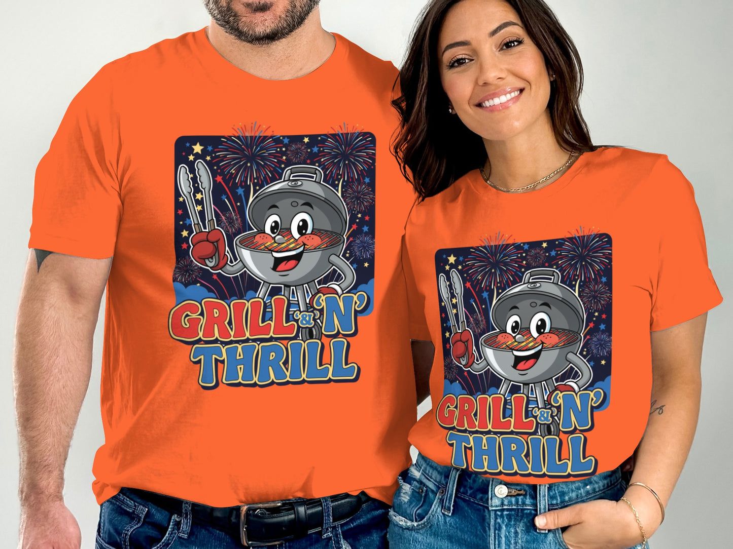Two people wear orange t-shirts with a cartoon grill and fireworks.
