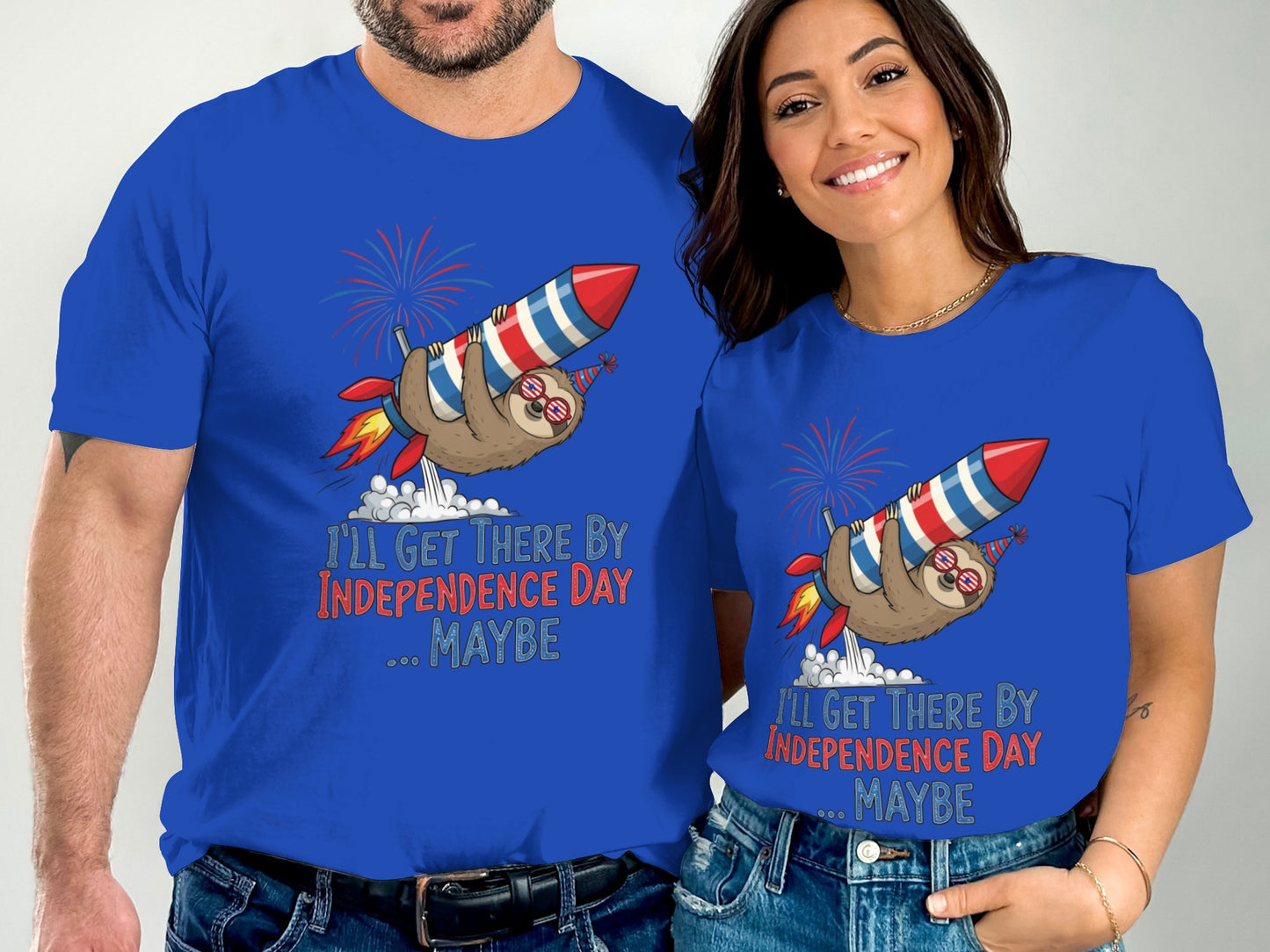 Couple wearing blue t-shirts with a sloth on a rocket and Independence Day text.