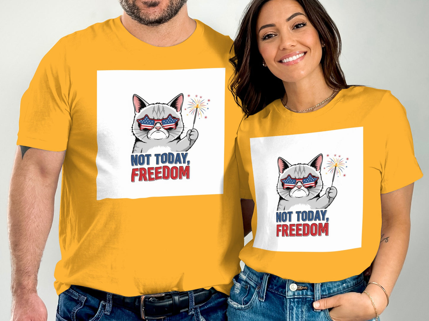 Man and woman wearing yellow t-shirts with a cat graphic and "NOT TODAY, FREEDOM".