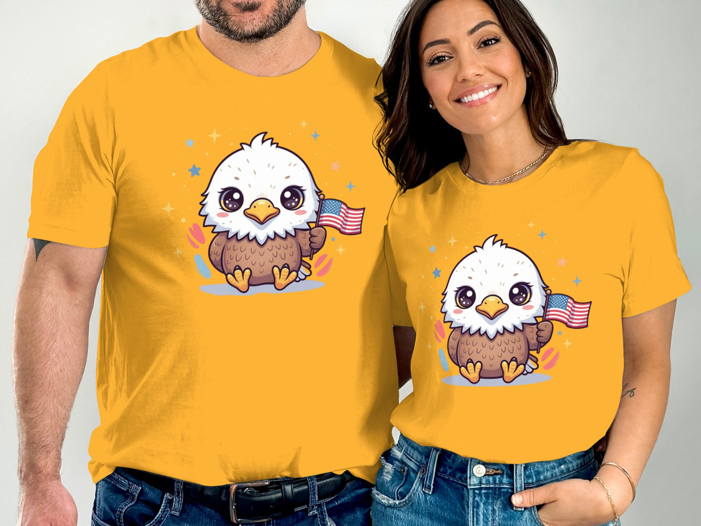 Couple wearing yellow t-shirts with cute cartoon eagles holding American flags.