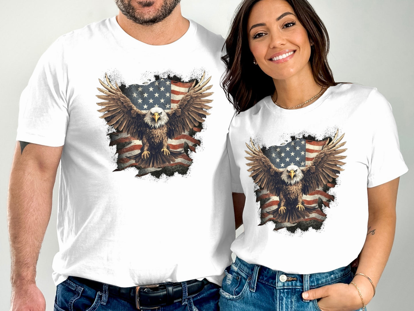 Two people wearing white t-shirts with a distressed eagle and American flag graphic.
