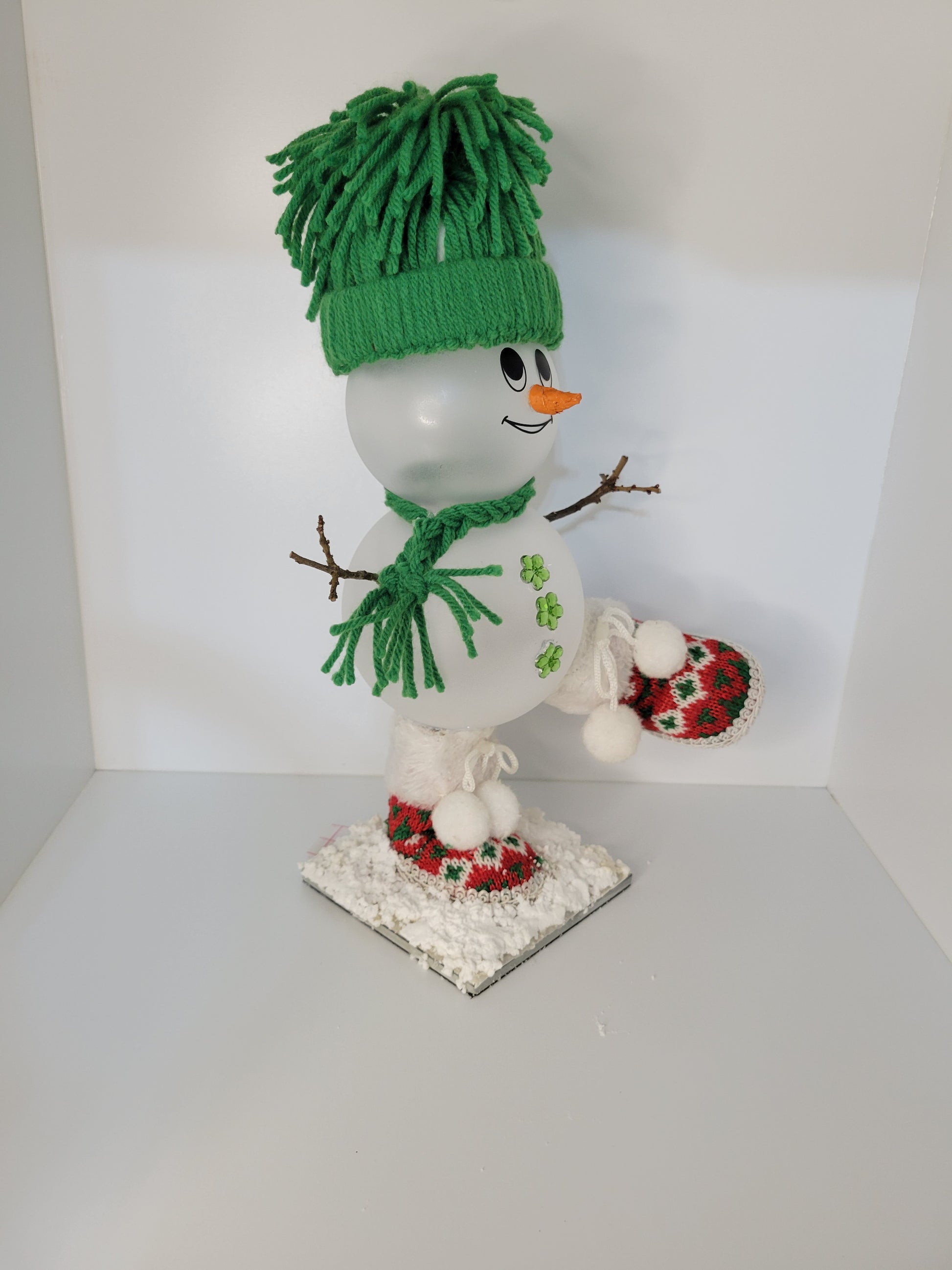 Adorable Snowman Figure with Green Winter Hat