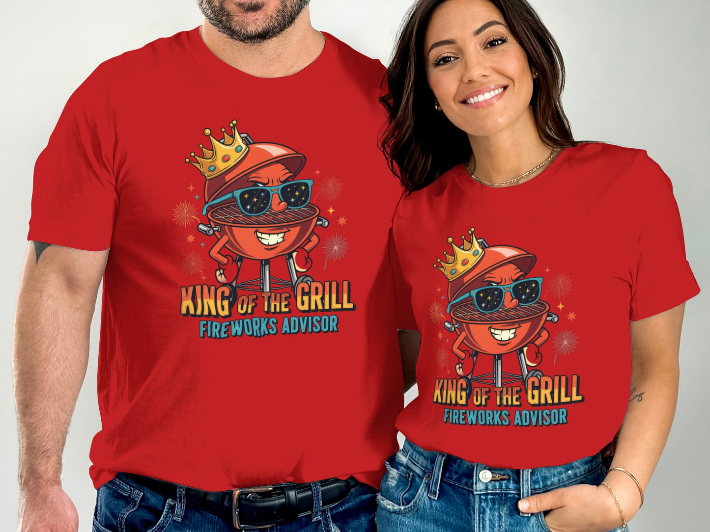 Couple wearing matching red t-shirts with a cartoon grill celebrating fireworks.