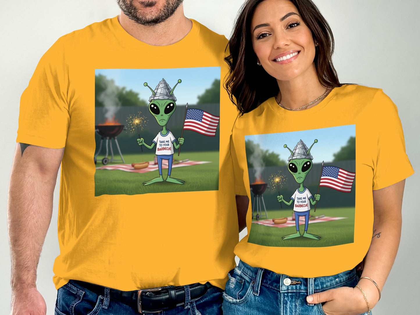 Alien in t-shirt with flag and fireworks at a barbecue.