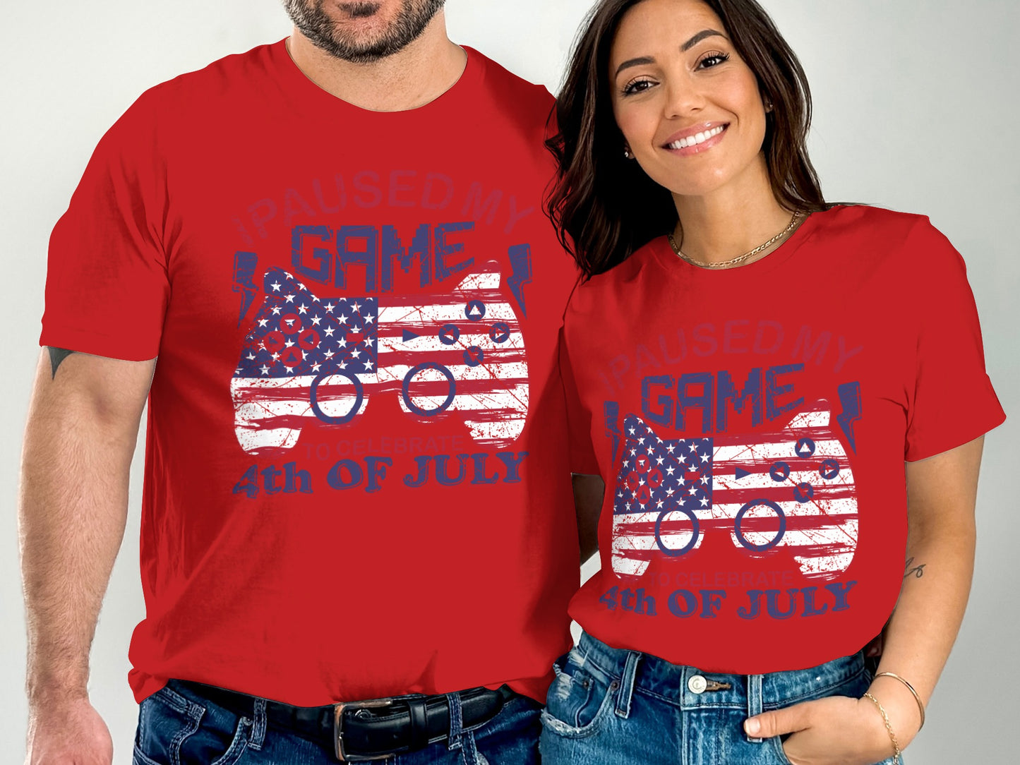 Red t-shirts with "Paused My Game 4th of July" text and distressed American flag controller graphic.