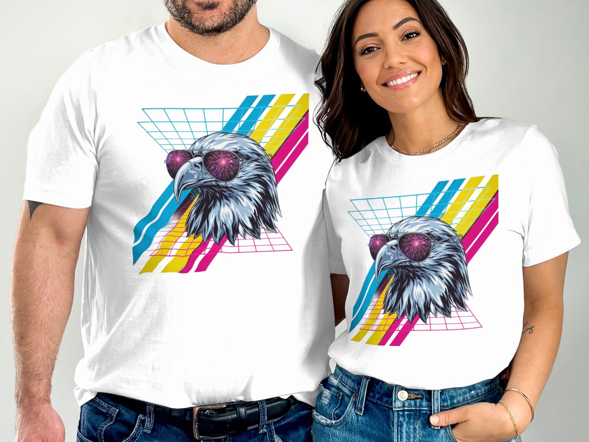 Two people wear white t-shirts featuring a stylized eagle head with sunglasses.