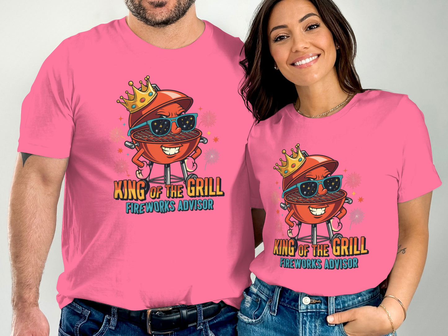 Two people wearing pink t-shirts with a cartoon grill character saying "King of the Grill."