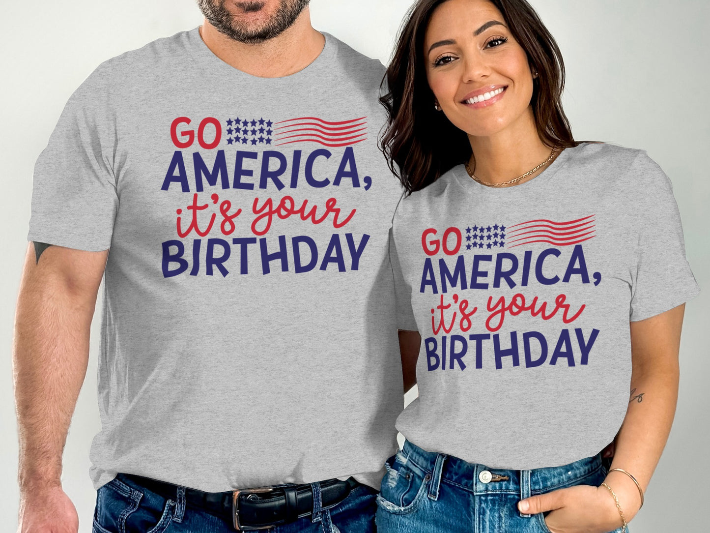 Two people wear gray t-shirts that say "GO AMERICA, IT'S YOUR BIRTHDAY".