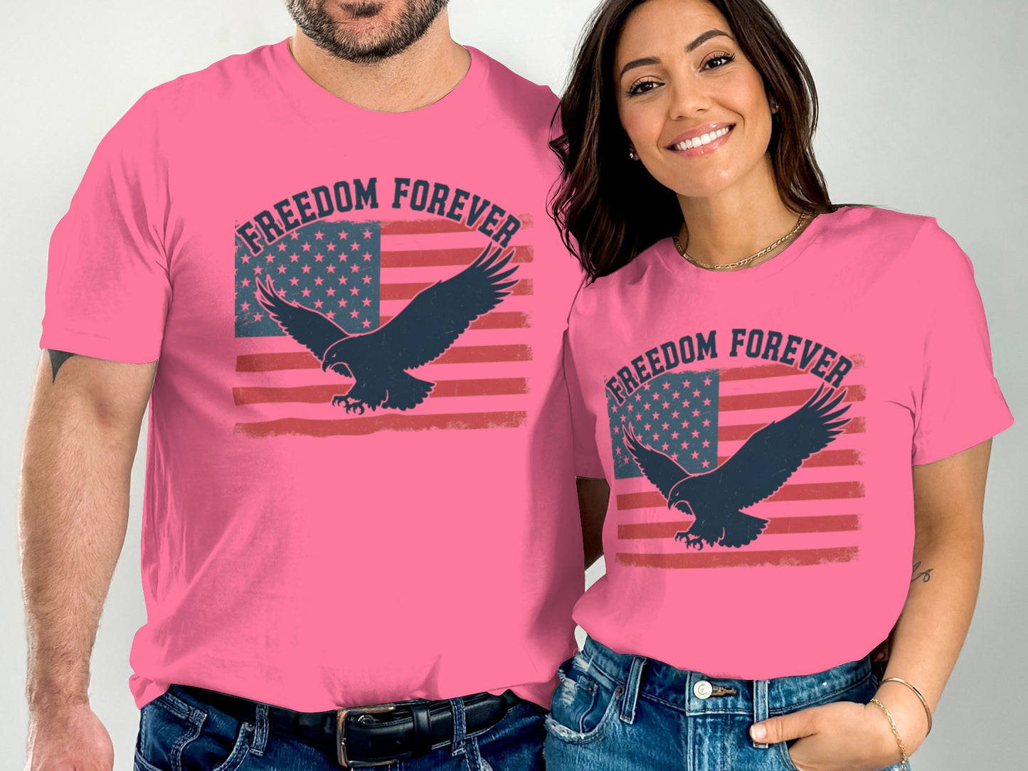Two people wear pink t-shirts with an American flag and eagle, reading "Freedom Forever."