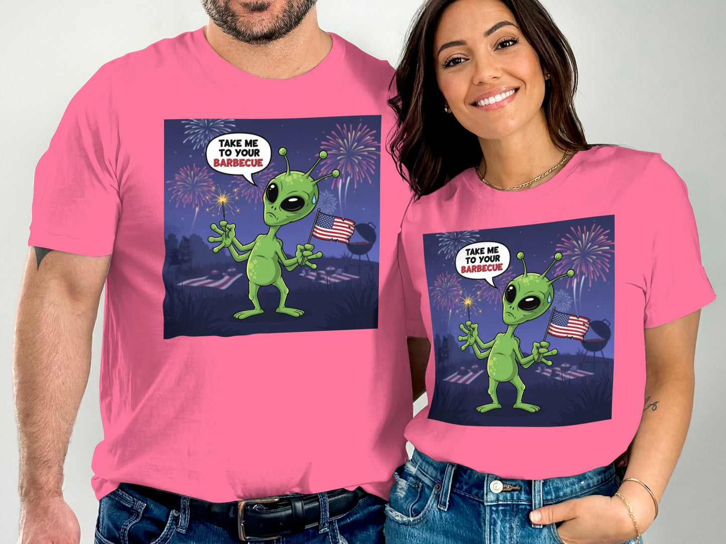 Pink t-shirts with alien holding sparkler and American flag, text "TAKE ME TO YOUR BARBECUE".
