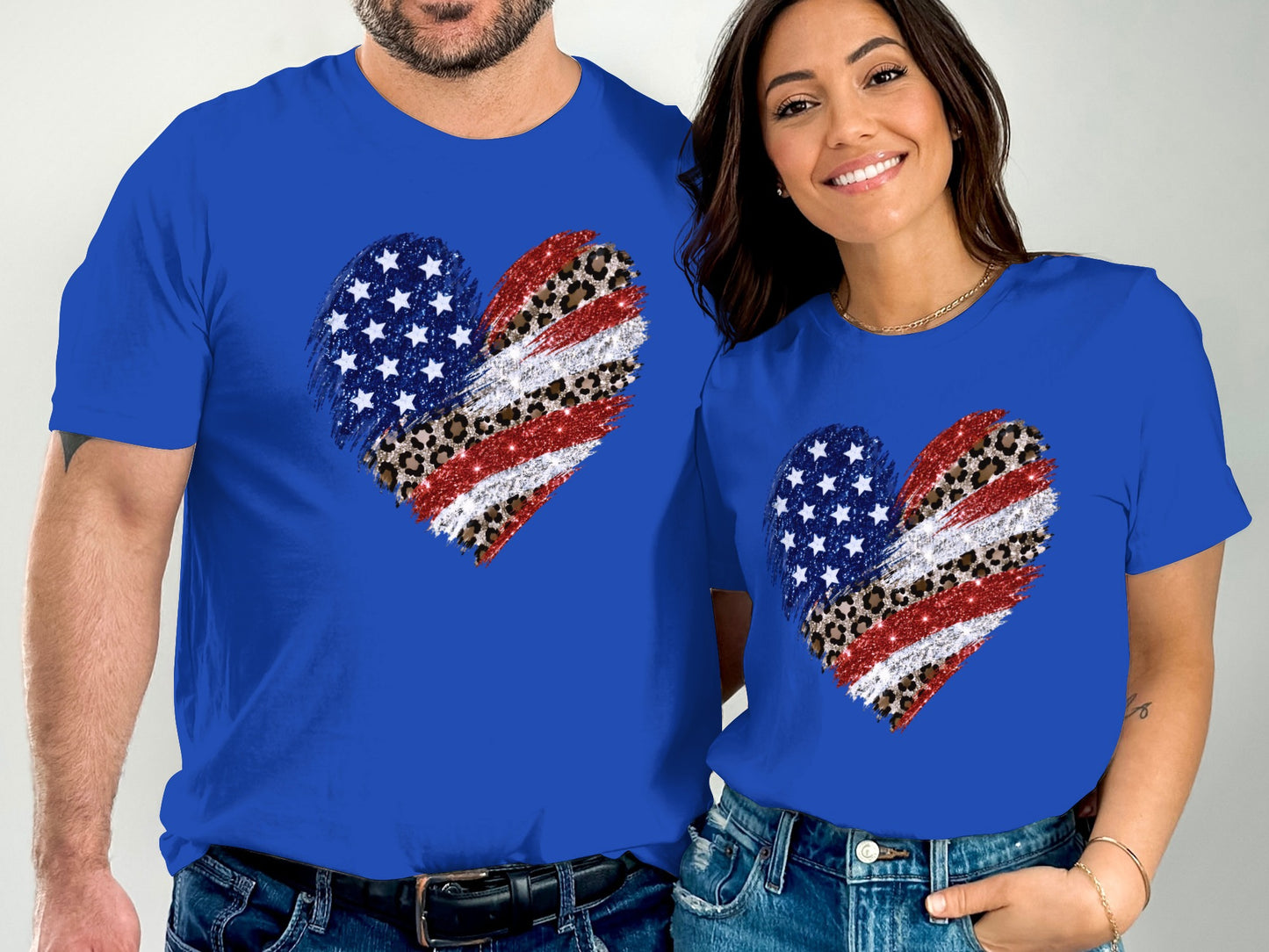 Couple wearing matching blue t-shirts with distressed American flag and leopard print heart designs.