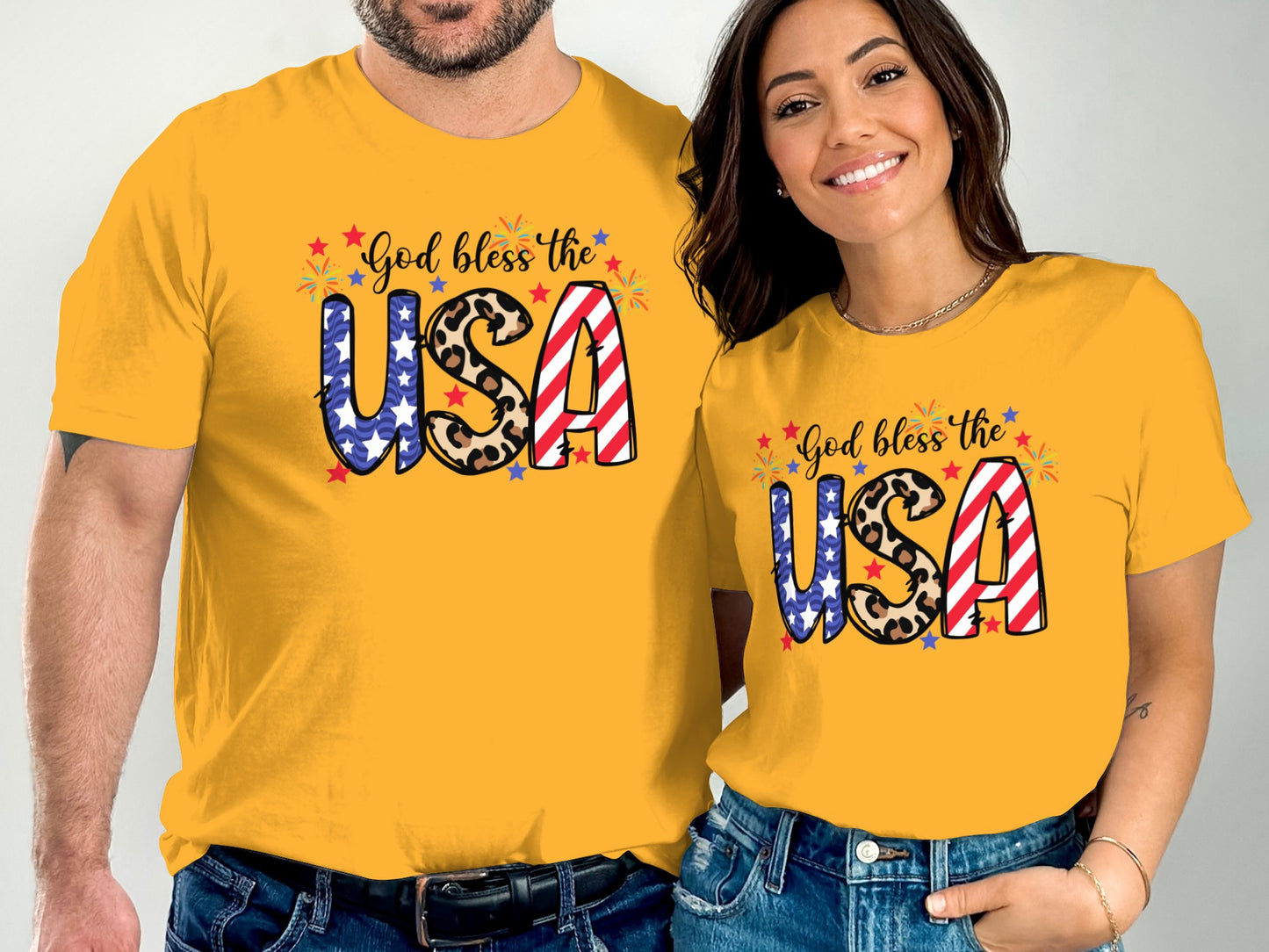 Couple wearing matching yellow t-shirts with "God bless the USA" and USA flag design.