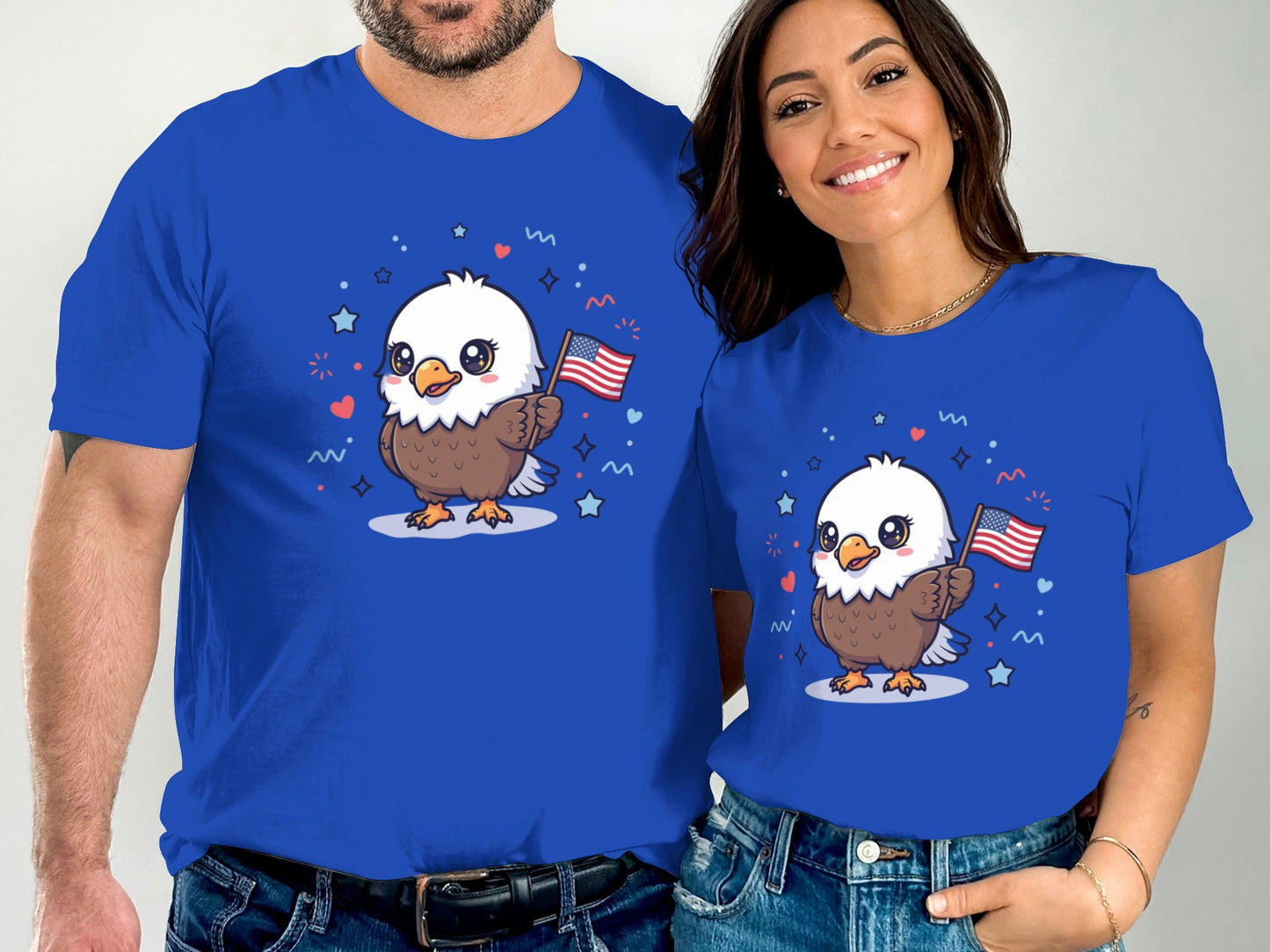 Two people in blue t-shirts featuring a cartoon eagle holding American flags.