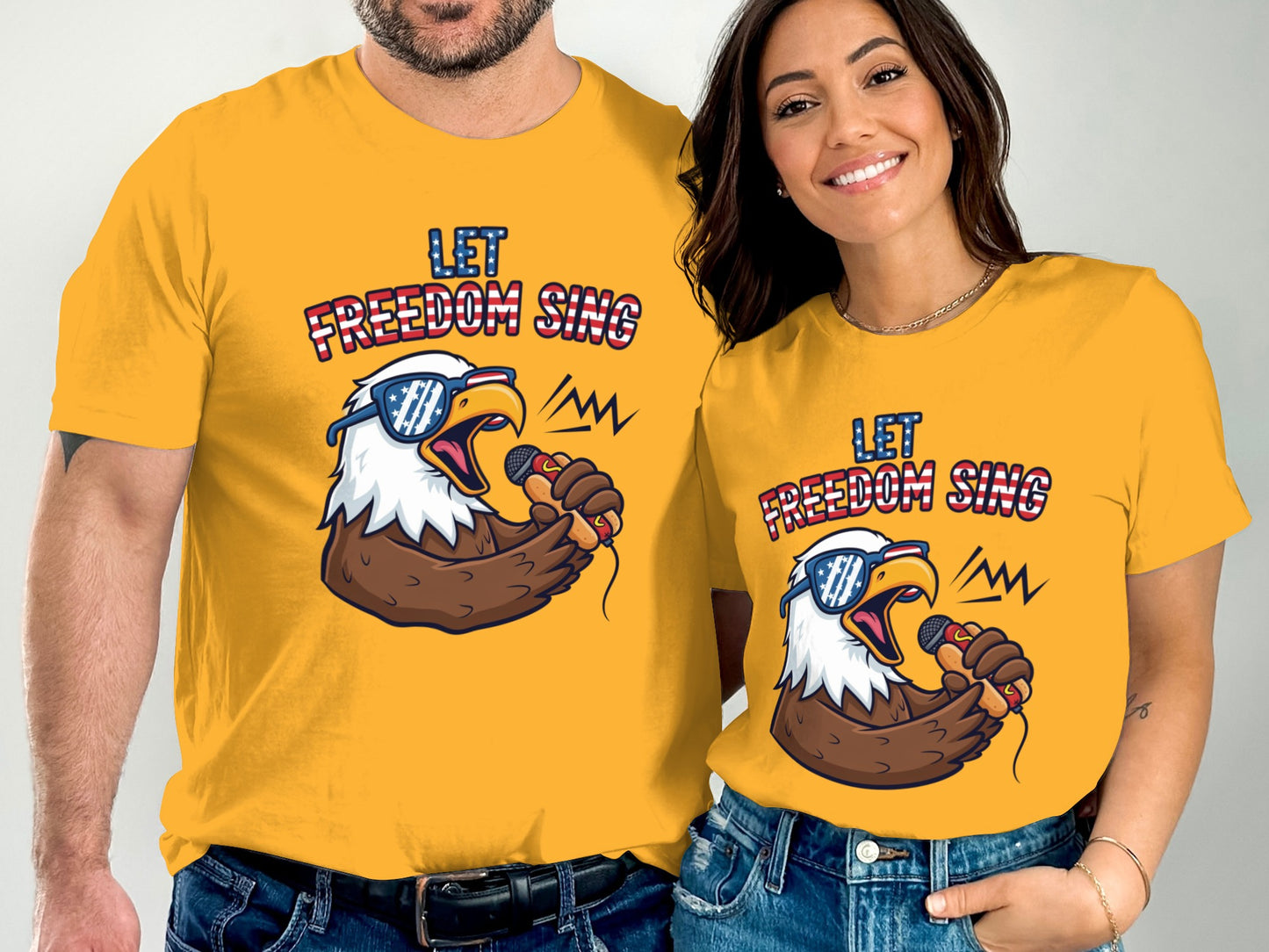 Couple wearing yellow t-shirts with eagle and "Let Freedom Sing" text.