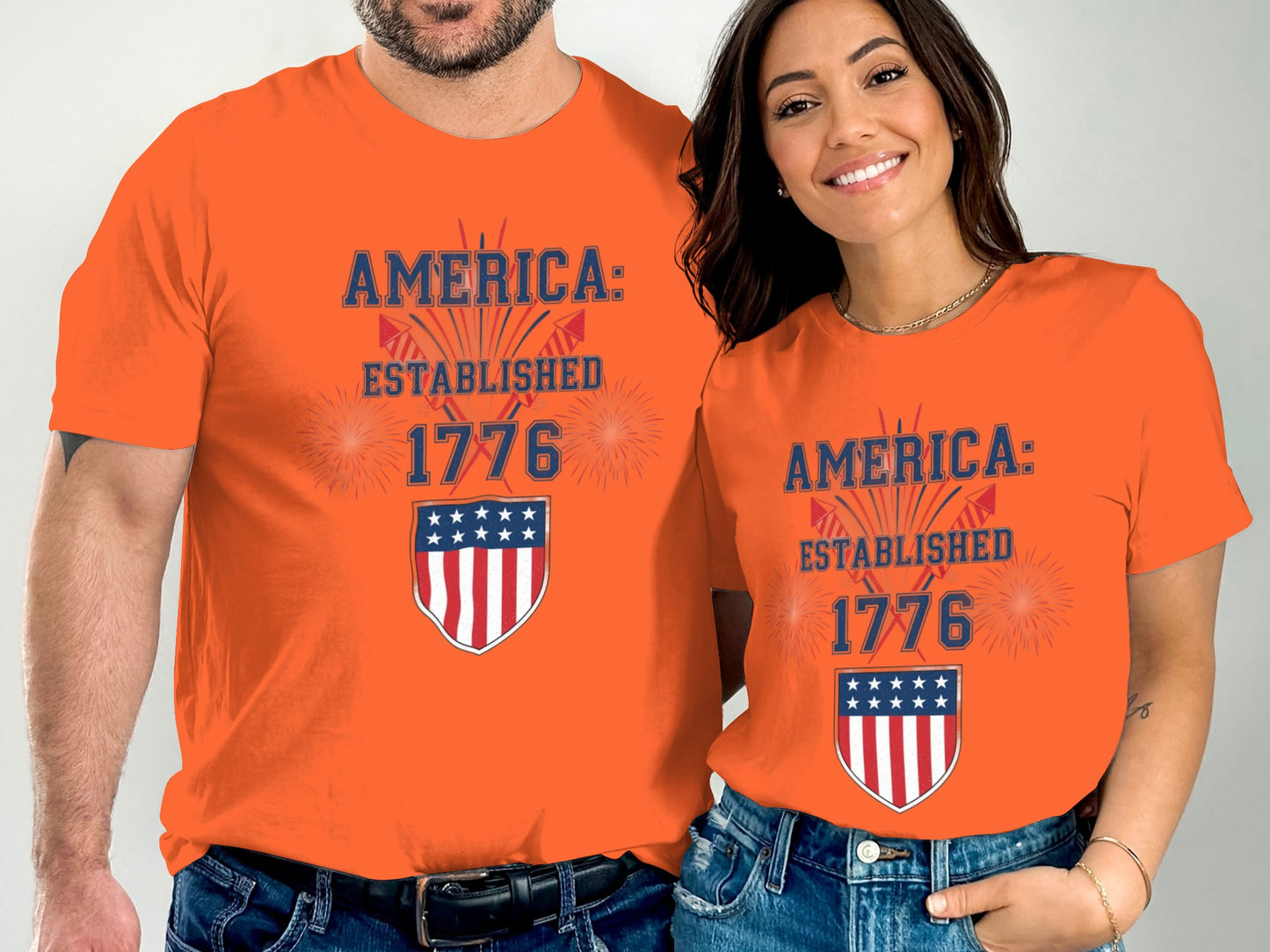 Orange t-shirts with "America: Established 1776" and US flag shield