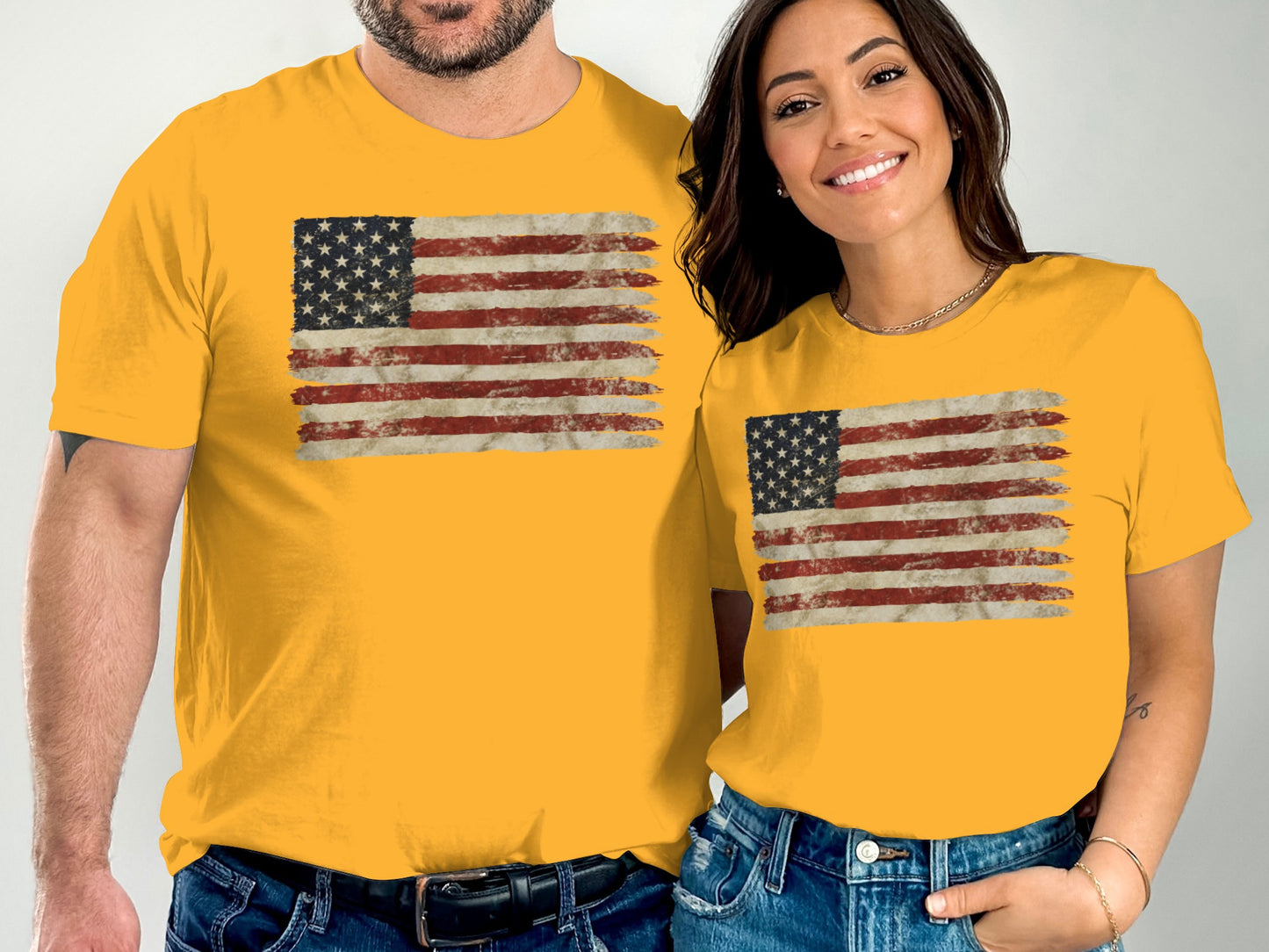 Couple wearing matching yellow t-shirts with distressed American flag graphic.