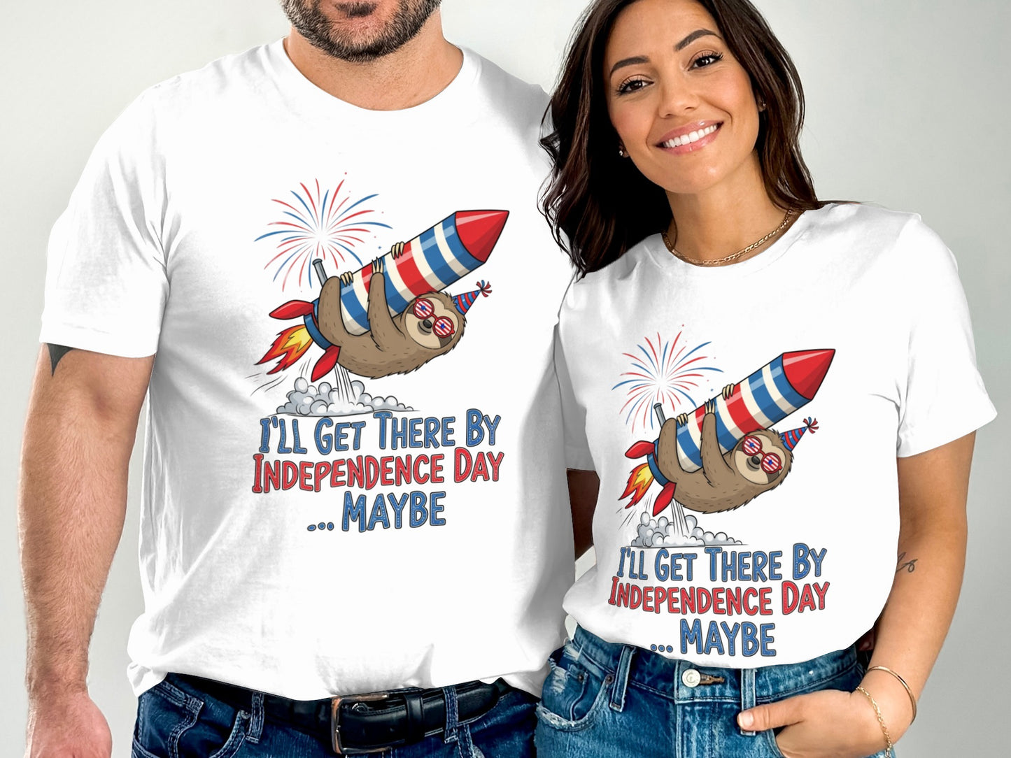 Couple wearing matching t-shirts with a sloth riding a rocket and text "I'll get there by Independence Day ... Maybe".