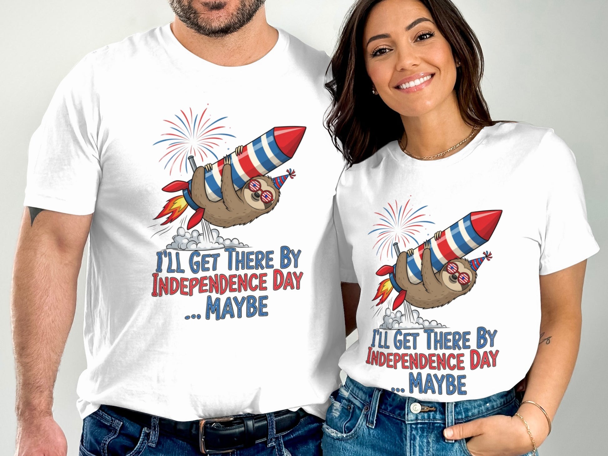Couple wearing matching t-shirts with a sloth riding a rocket and text "I'll get there by Independence Day ... Maybe".