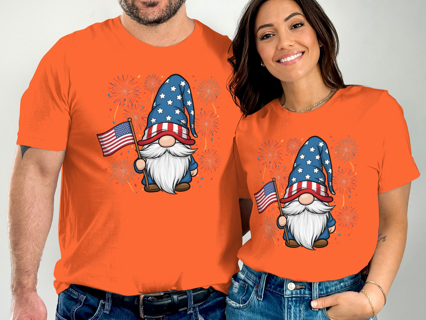Two people in orange t-shirts with matching gnome and flag graphics.
