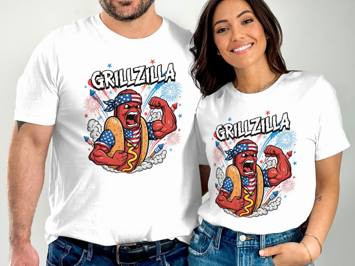 Two people wear matching t-shirts with "Grillzilla" text and a muscular hot dog character.