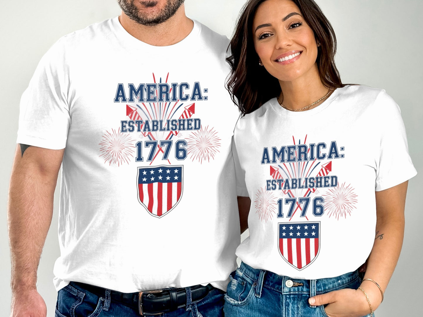White t-shirts with "America: Established 1776" and a shield design.