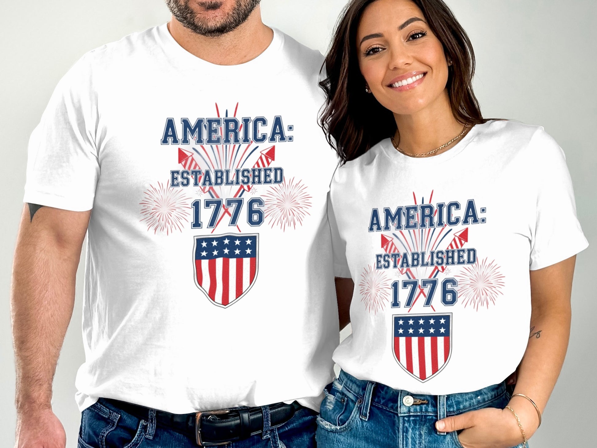 White t-shirts with "America: Established 1776" and a shield design.
